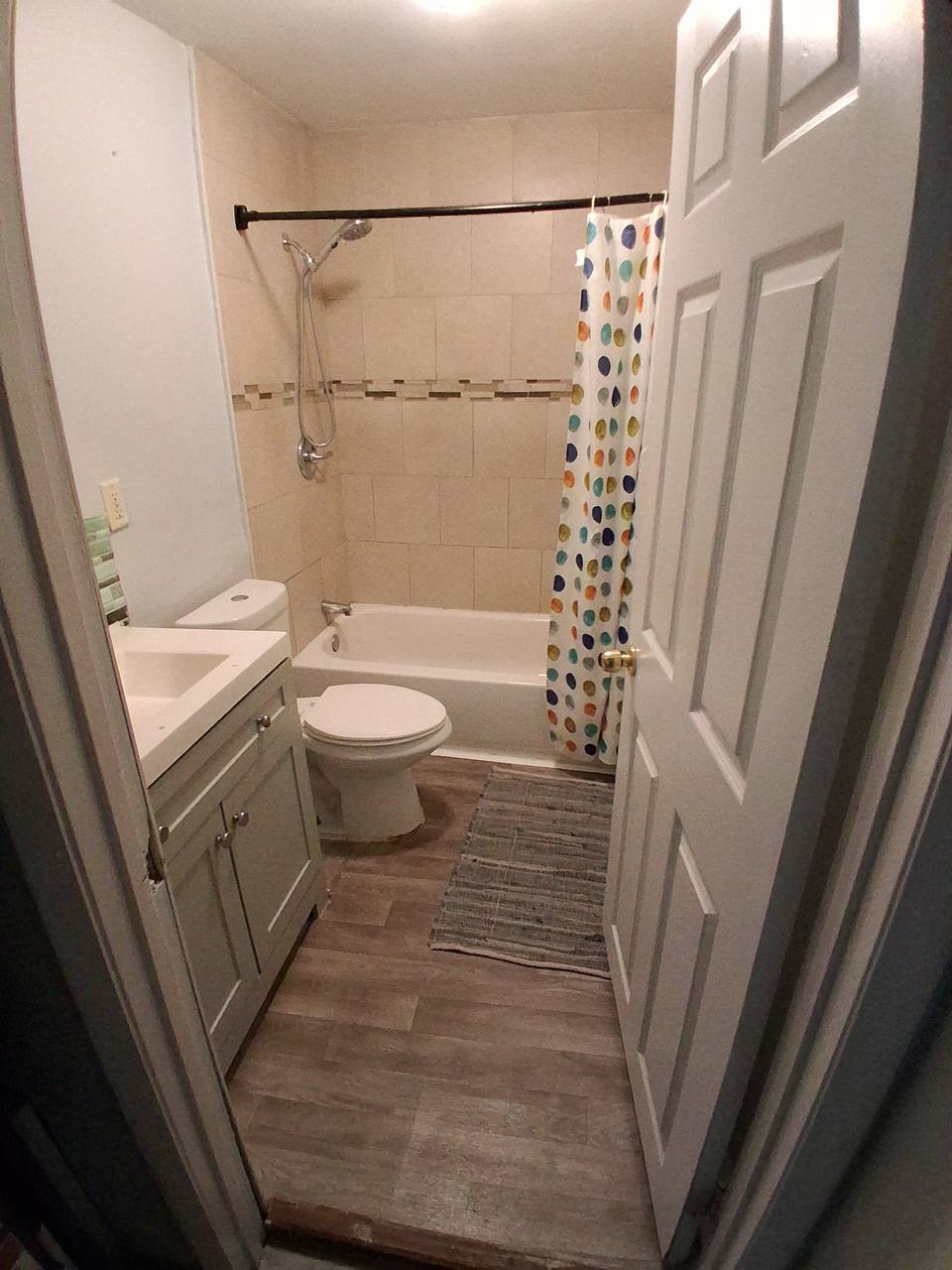 Archived shared bathroom with vanity, toilet, and tub-shower