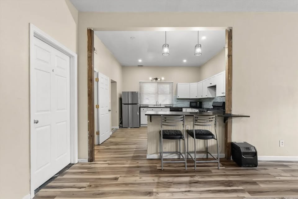 Kitchen and hallway view with dining table