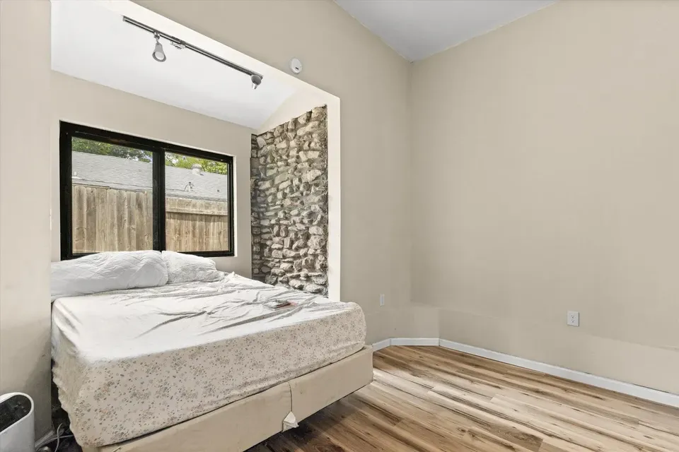 Bedroom with stone accent wall from the 300 Ripley Street Facebook listing